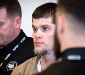 Patrick Schroeder is taken from the courtroom after a hearing on April 19, 2018. Schroeder, a Nebraska death row inmate who strangled his cellmate after complaining he talked too much, died Monday, Aug. 29, 2022, at the state prison in Tecumseh. Officials said they have not determined how Schroeder, 45, died. (Kent Sievers/Omaha World-Herald via AP, File)