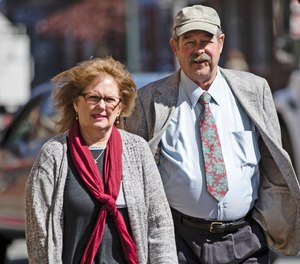 Deborah Frein, left, and Eugene Michael Frein, right, the parents of Eric Frein, walk to the Chester County Justice Center.