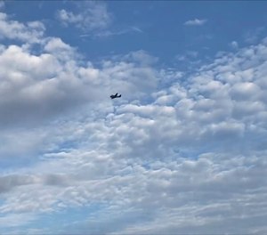 A small airplane circles over Tupelo, Miss., on Saturday, Sept. 3, 2022. Police say the pilot of the small airplane is threatening to crash the aircraft into a Walmart store. The Tupelo Police Department said that the Walmart and a nearby convenience store had been evacuated.