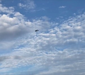 A small airplane circles over Tupelo, Miss., on Saturday, Sept. 3, 2022. Police say the pilot of the small airplane is threatening to crash the aircraft into a Walmart store. The Tupelo Police Department said that the Walmart and a nearby convenience store had been evacuated.