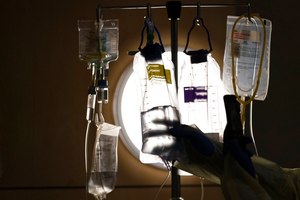 A nurse checks on IV fluids while talking to a COVID-19 patient at Providence Holy Cross Medical Center in Los Angeles on Dec. 13, 2021. A majority of adults in the U.S. say healthcare is not handled well in the country.