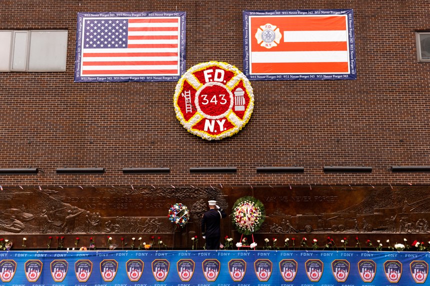 A firefighter salutes outside the FDNY Engine 10, Ladder 10 fire station near the commemoration ceremony on the 21st anniversary of the September 11, 2001, terror attacks on Sunday, Sept. 11, 2022, in New York.