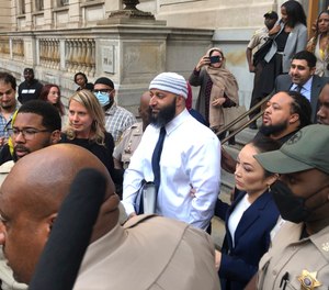 Adnan Syed, center, leaves the Elijah E. Cummings Courthouse, Monday, Sept. 19, 2022, in Baltimore. A judge has ordered the release of Syed after overturning his conviction for a 1999 murder that was chronicled in the hit podcast “Serial.”