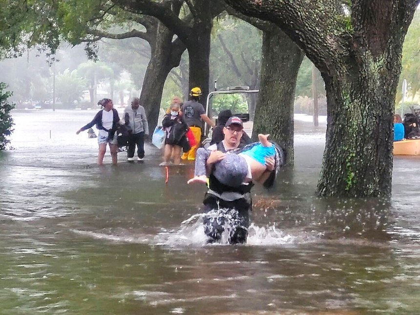 Firefighters in Orange County, Fla., help people stranded by Hurricane Ian early Thursday.