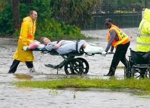 First responders transport a person out of the Avante nursing home in the aftermath of Hurricane Ian on Thursday in Orlando. Hurricane Ian carved a path of destruction across Florida.