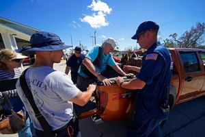 First responders help evacuate Andy Sherwood, a resident who rode out the storm after having a hip replacement five weeks earlier, in the aftermath of Hurricane Ian on Pine Island, in Florida's Lee County, on Sunday.