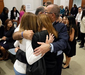 Linda Beigel Schulman, Michael Schulman, Patricia Padauy Oliver and Fred Guttenberg, families of the victims, embrace in the courtroom while waiting for an expected verdict in the penalty phase of the trial of Marjory Stoneman Douglas High School shooter Nikolas Cruz at the Broward County Courthouse in Fort Lauderdale, Fla. on Thursday, Oct. 13, 2022.