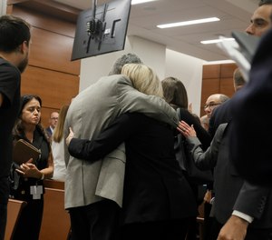 Tom and Gena Hoyer exit the courtroom following the verdict in the trial of Marjory Stoneman Douglas High School shooter at the Broward County Courthouse in Fort Lauderdale, Fla., on Thursday, Oct. 13, 2022. The Hoyer's son, Luke, was killed in the 2018 shootings.
