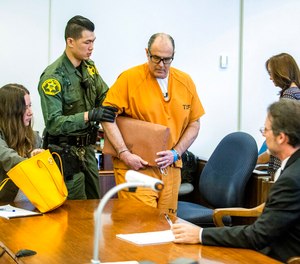 Scott Dekraai is lead to his seat beside his attorney Scott Sanders, right, in Orange County Superior Court in Santa Ana, Calif., on Friday, Aug. 18, 2017. Dekraai, a Southern California mass killer, will be spared the death penalty amid a long-running scandal over local authorities' use of jailhouse informants. The U.S. Justice Department said Thursday that the sheriff's department and prosecutors in Orange County, California, ran an extensive jailhouse informant program for years that violated the rights of criminal defendants.