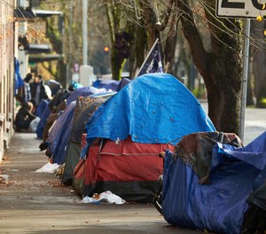 Tents line the sidewalk on SW Clay St in Portland, Ore., on Dec. 9, 2020. Portland Mayor Ted Wheeler announced this morning Friday, Oct. 21, 2022, that the city will ban homeless street camping in the coming months as it creates new, large