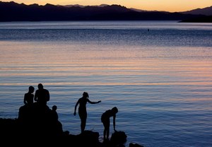 In this May 27, 2011 file photo, children fish at twilight at the edge of Kingman Wash at Lake Mead National Recreation Area in Arizona. Regional health officials say a Las Vegas-area boy died from a rare brain-eating amoeba that investigators think he was exposed to in warm waters at Lake Mead.