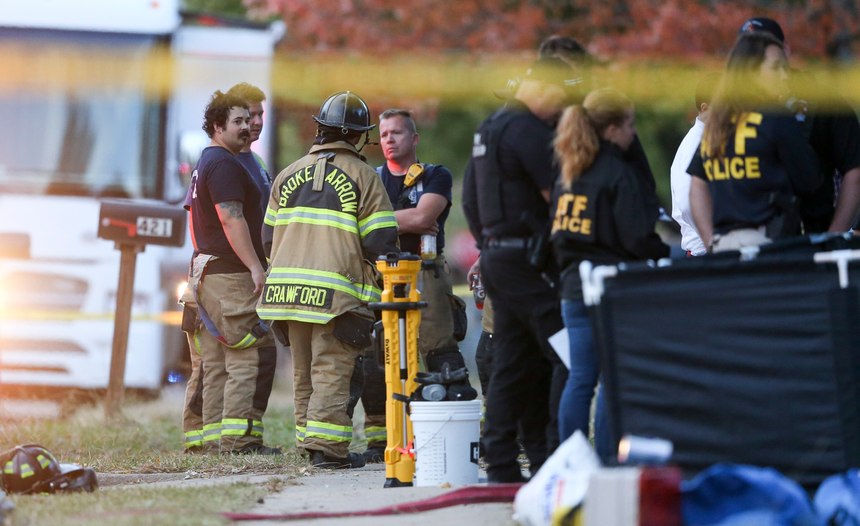 Broken Arrow, Okla., police and fire department investigate the scene of a fire with multiple fatalities at the corner South Hickory Ave. and West Galveston St. on Thursday, Oct. 27, 2022. Eight people were found dead Thursday after a fire was extinguished at a Tulsa-area house, and police said they were investigating the deaths as homicides.