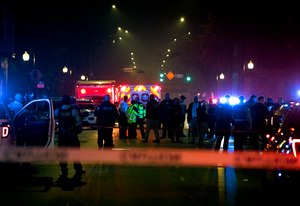 Chicago police officers and EMS providers work at the scene of a mass shooting near Polk Street and California Avenue on the city's West Side on Monday, Oct. 31, 2022. Chicago Police said that several people were injured in a drive-by shooting Halloween night, including three children.