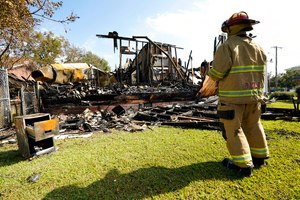 A firefighter observes the remnants of the burned Epiphany Lutheran Church near midtown Jackson, Miss., on Tuesday. Authorities are on the hunt for a suspected arsonist.