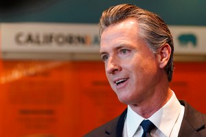 California Gov. Gavin Newsom talks to reporters after voting in Sacramento, Calif., on Tuesday. Newsom called Proposition 30 a “Trojan horse that puts corporate welfare above the fiscal welfare of our entire state.” He also argued that it was a “special interest carve-out” devised to benefit a single company, referring to Lyft.