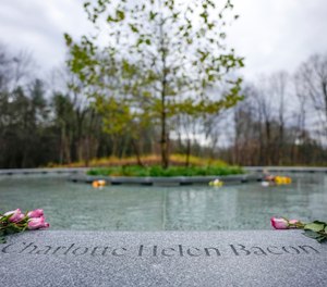 Flowers lay next to the name of Charlotte Bacon, carved in the stone of a memorial dedicated to the victims of the Sandy Hook Elementary School shooting, in Newtown, Conn., Sunday, Nov. 13, 2022.