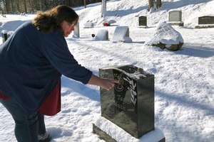 Deb Walker, of Chester, Vermont, visits the grave of her daughter Brooke Goodwin, on Dec. 9, 2021, in Chester. Goodwin, 23, died in March of 2021 of a fatal overdose of fentanyl and xylazine. Government data released on Wednesday suggests U.S. overdose deaths have stopped rising in 2022 — a hopeful sign of at least a plateau in a public health crisis that has been worsening for decades.