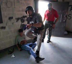 City of Hialeah Police Commander Orlando Salvat is pictured during a training session, Tuesday, Nov. 15, 2022, in Hialeah, Fla. The drill was part of the University of Miami Miller School of Medicine's Gordon Center for Simulation & Innovation in Medical Education active shooter training where police and fire rescue personnel train together so that they can provide aid to victims quicker during a hostile situation.