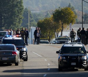 Investigators gather at a scene where an SUV struck Los Angeles County sheriff's recruits in Whittier, Calif., Wednesday, Nov. 16, 2022. The vehicle struck several Los Angeles County sheriff's recruits on a training run around dawn Wednesday, some were critically injured, authorities said.