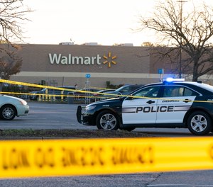 Law enforcement work the scene of a mass shooting at a Walmart, Wednesday, Nov. 23, 2022, in Chesapeake, Va.