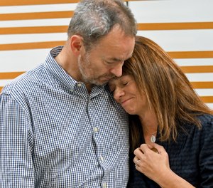 Simon and Sally Glass comfort each other during an emotional news conference about the death of their son, Christian Glass, Sept. 13, 2022, in Denver.