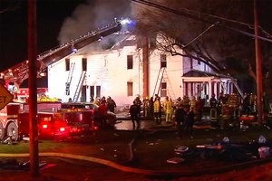 Firefighters work on the scene of a house fire Wednesday in West Penn Township, west of Allentown, Pa. Pennsylvania State Police say two firefighters died responding to the blaze where a body was found, while two people who lived in the home got out safely.