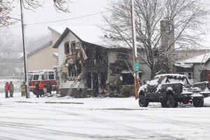 Watertown firefighters work the scene of a house fire, Friday in Watertown, Wis. Three people died in the house fire in the southeastern Wisconsin city, the fire department said.