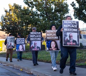 Prison workers and union officials, angered by the AP's investigation into Hinkle and the agency’s response defending him, picketed Monday outside a Bureau of Prisons Western Regional Office in Stockton, California.
