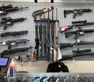Firearms are displayed at a gun shop in Salem, Ore.
