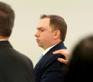 Aaron Dean stands with his defense team as the jury leaves the 396th District Court to start its deliberations on Wednesday, Dec. 14, 2022, in Fort Worth, Texas.