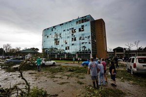 People survey damage following a tornado at the Iberia Medical Center on Wednesday.