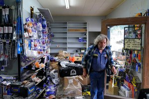 Kenny Ransbottom walks through debris inside his auto parts store after an earthquake in Rio Dell, Calif., Tuesday, Dec. 20, 2022. A strong earthquake shook a rural stretch of Northern California early Tuesday, jolting residents awake, cutting off power to 72,000 people.