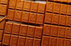 Candy bars marked with Colorado's required diamond-shaped stamp noting that the product contains marijuana, are displayed in Denver in 2016. State officials require the stamp to be put directly on edibles after complaints that the treats look too much like their non-intoxicating counterparts.
