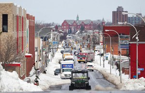 Vehicles drive down Jefferson Avenue in Buffalo. N.Y., on Wednesday. Clean-up efforts remain underway after a blizzard hit four western New York counties. More than three dozen deaths have been reported.