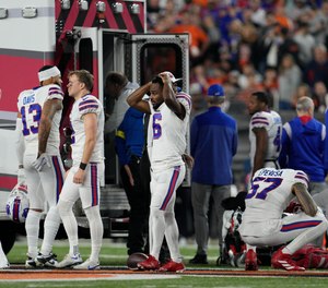 Buffalo Bills players react as teammate Damar Hamlin is examined during the first half of an NFL football game against the Cincinnati Bengals, Monday, Jan. 2, 2023, in Cincinnati.