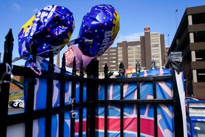 Balloons and a Buffalo Bills flag sit on a fence Thursday outside UC Medical Center, where Buffalo Bills safety Damar Hamlin remains hospitalized.