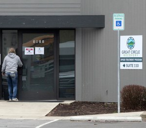 A woman enters the Great Circle drug treatment center in Salem, Ore.