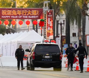 Police officers stand outside a ballroom dance club in Monterey Park, Calif., Sunday, Jan. 22, 2023.