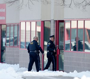 Law enforcement officers enter the Starts Right Here building, Monday, Jan. 23, 2023, in Des Moines, Iowa.