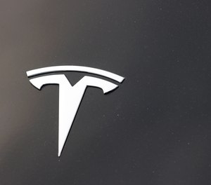 The Tesla company logo is seen on the hood of an unsold vehicle at a dealership on Aug. 9, 2020, in Littleton, Colo.