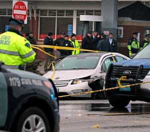 Police investigate the scene of a shooting at the intersection of Route 9 and Hammond Street that started near Brigham and Women's Hospital, Feb. 7, 2020, in Chestnut Hill, Mass.