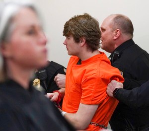 Payton Gendron is whisked out of the courtroom after a man charged at Gendron during his sentencing for charges including murder and domestic terrorism motivated by hate in an Erie County court room in Buffalo, N.Y., on Wednesday, Feb 15, 2023. Gendron, a white supremacist who killed 10 Black people at a Buffalo supermarket was sentenced to life in prison without parole.