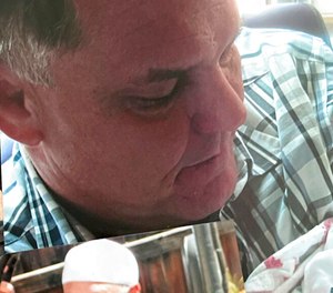 In this undated photo provided by Kenda James, Kevin Dizmang holds his granddaughter as an infant. The death of Dizmang, who was handcuffed after a mental health team responded to a call of him walking out into traffic last year has been ruled a homicide, according to an autopsy report released on Feb. 15, 2023, by lawyers for his family.