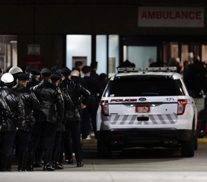 Police gather at Temple University Hospital following a fatal shooting of a Temple University police officer near the campus on Saturday, Feb. 18, 2023, in Philadelphia.