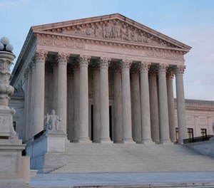 The setting sun illuminates the Supreme Court building on Capitol Hill.