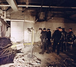 New York City police and firefighters inspect the bomb crater inside an underground parking garage of New York's World Trade Center on Feb. 27, 1993, the day after an explosion tore through it.