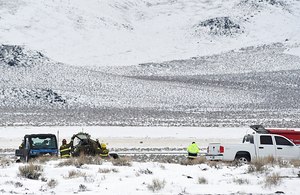 A Care Flight plane carrying a pilot, a flight nurse, a flight paramedic, a patient and a member of the patient's family is seen Saturday, the day after the crash in Lyon County, Nev.