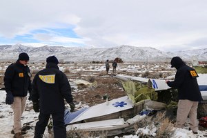 This photo provided by The National Transportation Safety Board shows NTSB investigators on Sunday, Feb. 26, 2023, at the crash site in Dayton, Nev. documenting the wreckage of a Pilatus PC-12 airplane a medical air transport flight operated by Guardian Flight that crashed on Friday, Feb. 24, while enroute from Reno, Nevada, to Salt Lake City.