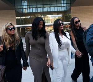 Vanessa Bryant, center, Kobe Bryant's widow, leaves a federal courthouse with her daughter Natalia, center left, soccer player Sydney Leroux, center right, in Los Angeles, Wednesday, Aug. 24, 2022.