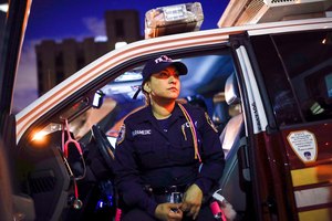 FDNY Paramedic Elizabeth Bonilla sits in her ambulance between calls on April 15, 2020, in the Bronx. She and three other New York City EMS providers, who said they were disciplined for speaking to the media during the first months of the COVID-19 pandemic, reached a settlement in their free speech lawsuit against the fire department and the city, their union announced Wednesday.